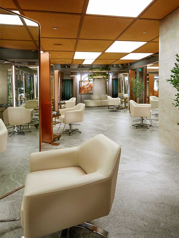 Open salon space with white styling chairs
