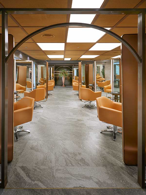 Modern salon with orange chairs and mirrors